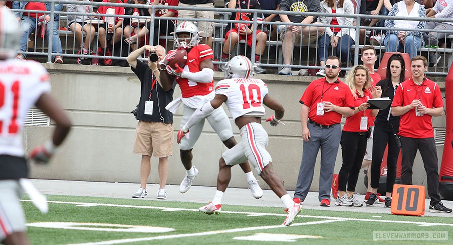 Johnnie Dixon hauls in a pass over Kendall Sheffield. 