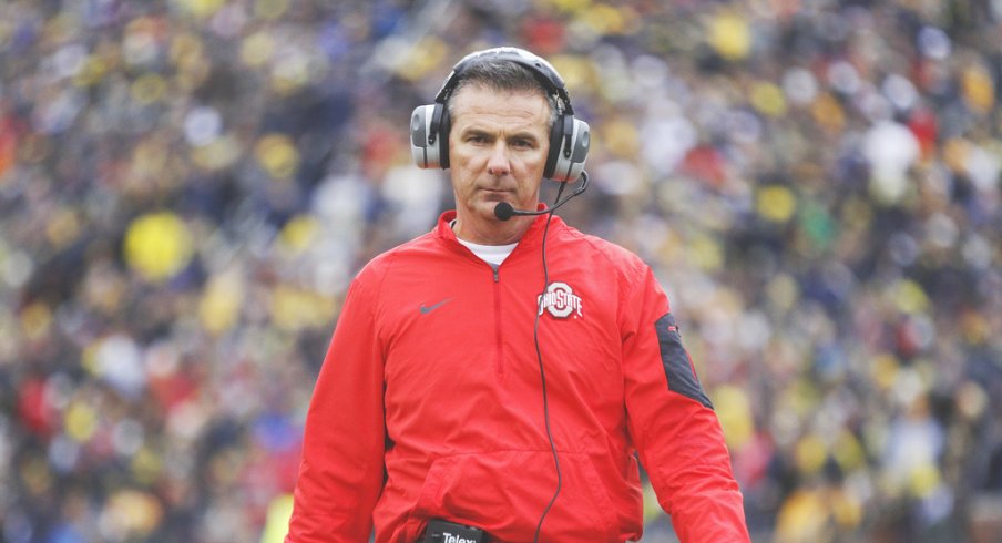 Urban Meyer strolls the sidelines at Michigan. 