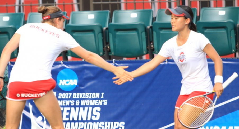 Sophomore Francesca Di Lorenzo and senior Miho Kowase high five after a doubles match.