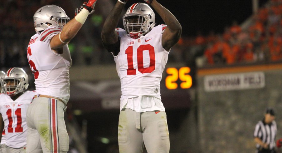 Sam Hubbard and Jalyn Holmes celebrate a fumble against Virginia Tech in 2015