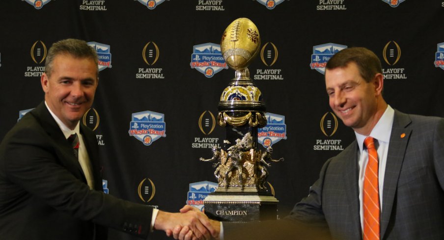 Ohio State head coach Urban Meyer and Clemson head coach Dabo Swinney shake hands.