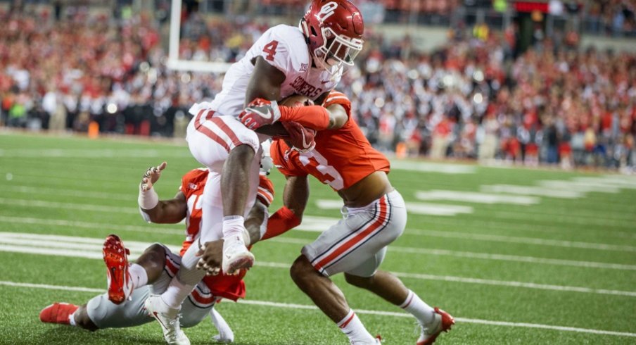 damon arnette attempts to tackle trey sermon as he scores