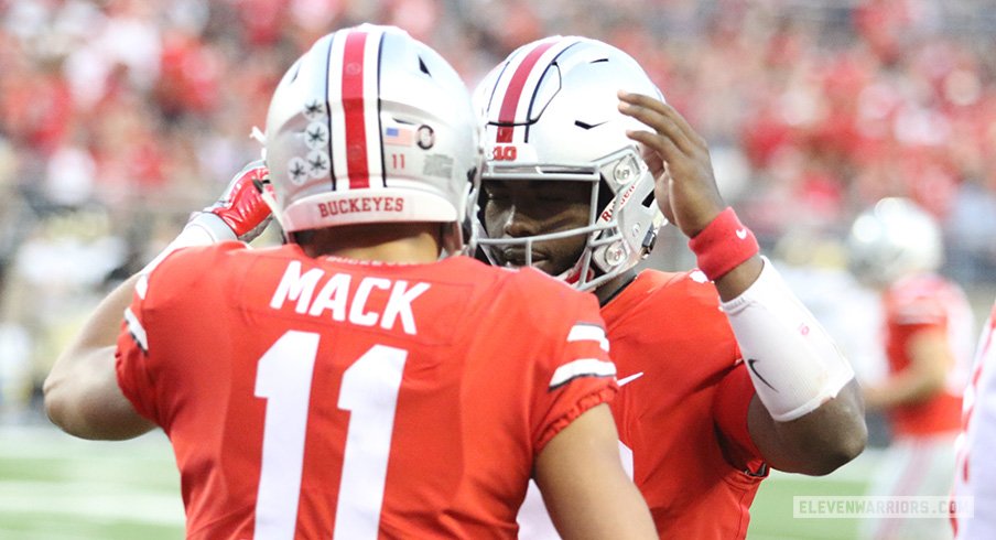 J.T. Barrett and Austin Mack celebrate a touchdown against Army.