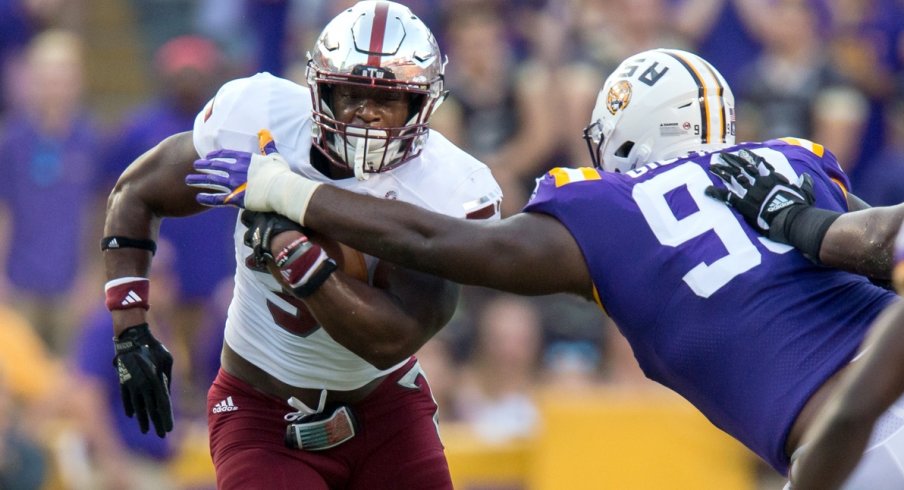 Sep 30, 2017; Baton Rouge, LA, USA; LSU Tigers nose tackle Greg Gilmore (99) tackles Troy Trojans running back Jordan Chunn (38) in the first quarter of the game between the LSU Tigers and the Troy Trojans at Tiger Stadium. Mandatory Credit: Stephen Lew-USA TODAY Sports