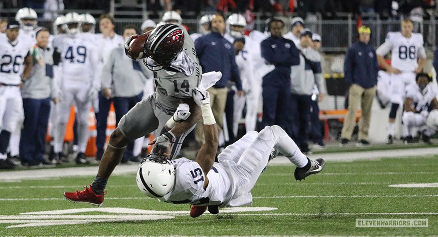 K.J. Hill punks a Penn State defensive back.