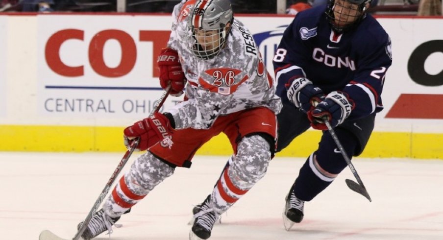 Ohio State's Mason Jobst battles battles a Connecticut Huskies player in a men's hockey game at Value City Arena. 