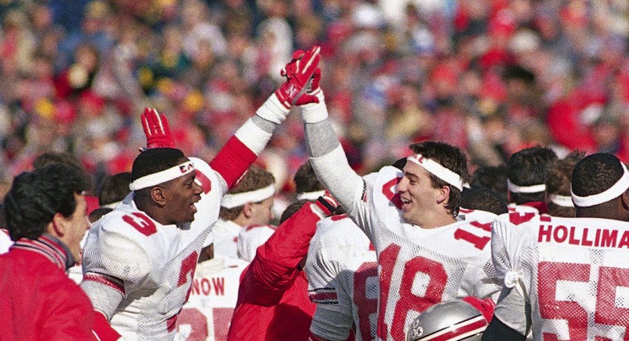 Ohio State players celebrated after wearing "Earle" headbands and beating Michigan in Earle Bruce's final game in 1987. (Robert Kozloff, Associated Press)