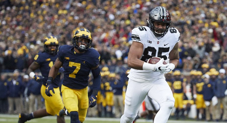 Marcus Baugh scores against Michigan.