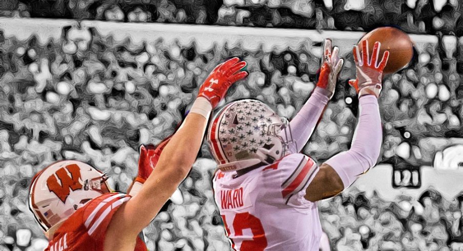 Dec 2, 2017; Indianapolis, IN, USA; Ohio State Buckeyes cornerback Denzel Ward (12) intercepts the ball while Wisconsin Badgers tight end Troy Fumagalli (81) defends in the first half in the Big Ten championship game at Lucas Oil Stadium. Mandatory Credit: Trevor Ruszkowski-USA TODAY Sports