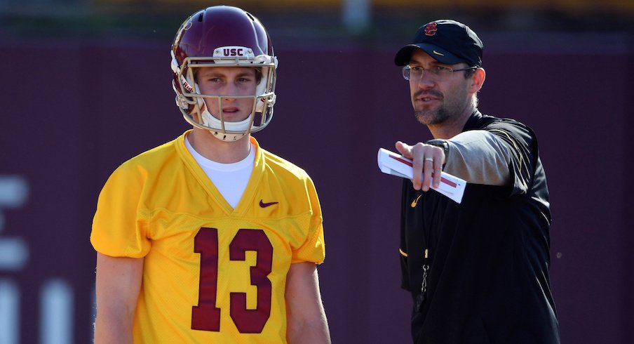 Former USC quarterbacks coach Tyson Helton coaches Trojans backup quarterback Jack Sears prior to the season.