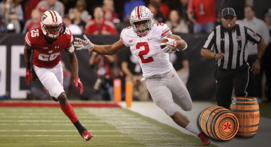 Dec 2, 2017; Indianapolis, IN, USA; Ohio State Buckeyes running back J.K. Dobbins (2) attempts to stay in bounds as he is chased by Wisconsin Badgers cornerback Derrick Tindal (25) in the third quarter in the Big Ten championship game at Lucas Oil Stadium. Mandatory Credit: Mark Hoffman/Milwaukee Journal Sentinel via USA TODAY Sports