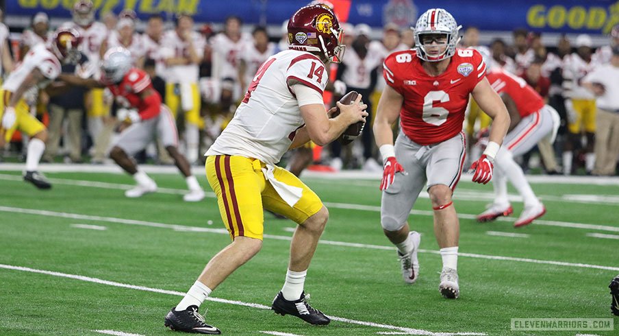 Sam Hubbard encroaches on Sam Darnold.