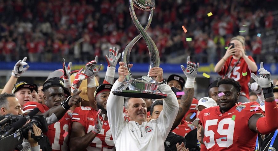 Dec 29, 2017; Arlington, TX, USA; Ohio State Buckeyes coach Urban Meyer holds the championship trophy after the 2017 Cotton Bowl against the Southern California Trojans at AT&T Stadium. Ohio State defeated USC 24-7. Mandatory Credit: Kirby Lee-USA TODAY Sports