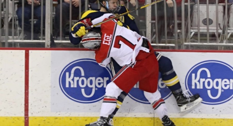 Buckeye defenseman Wyatt Ege tattoos a Michigan Wolverine.