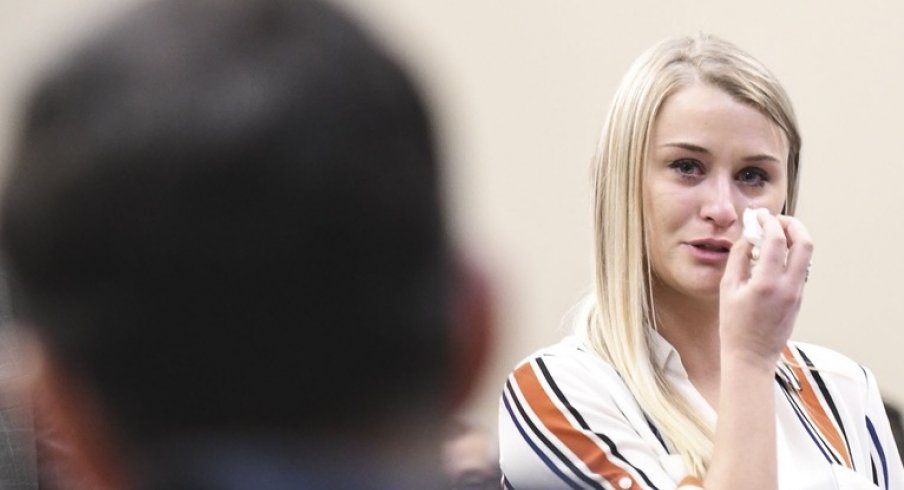 Jan 18, 2018; East Lansing, MI, USA; MSU student and former gymnast Christine Harrison addresses Larry Nassar during her victim impact statement in Circuit Judge Rosemarie Aquilina's courtroom, the third day of testimonials concerning the former sports medicine doctor who pled guilty to seven counts of sexual assault in Ingham County, and three in Eaton County. At her side is Larry Harrison, her dad, a retired Det. Sgt. with the Ingham County Sheriff's Department. Mandatory Credit: Matthew Dae Smith/Lansing