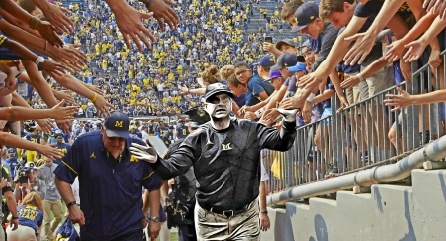 Sep 16, 2017; Ann Arbor, MI, USA; Michigan Wolverines head coach Jim Harbaugh high five with fans after defeating the Air Force Falcons at Michigan Stadium. Mandatory Credit: Rick Osentoski-USA TODAY Sports