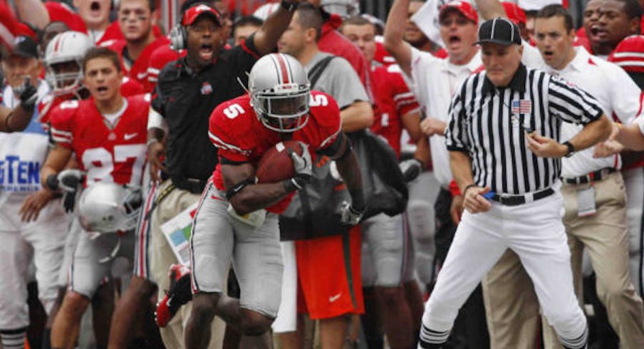 Chimdi Chekwa intercepts a pass against Miami in 2010 with Taver Johnson cheering in the background.