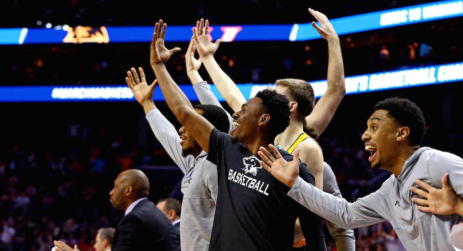 UMBC bench celebrates.