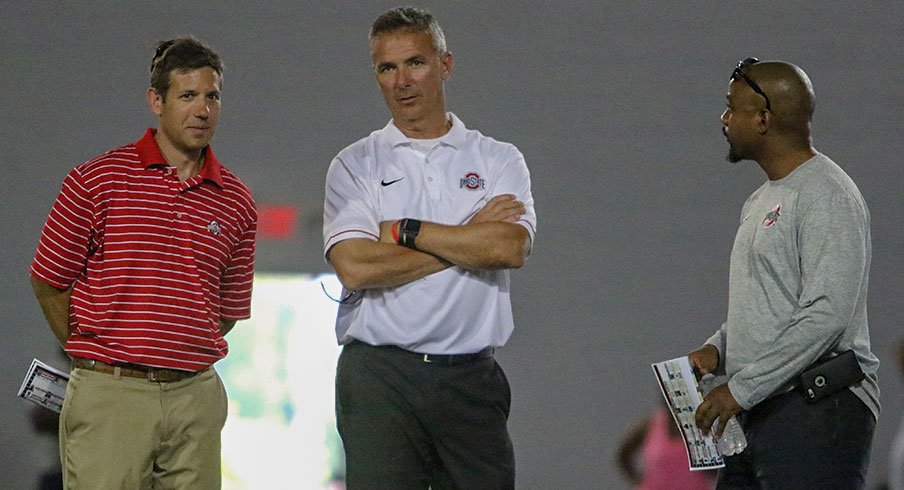 Director of player development Mark Pantoni, head coach Urban Meyer and assistant director of player personnel Eron Hodges