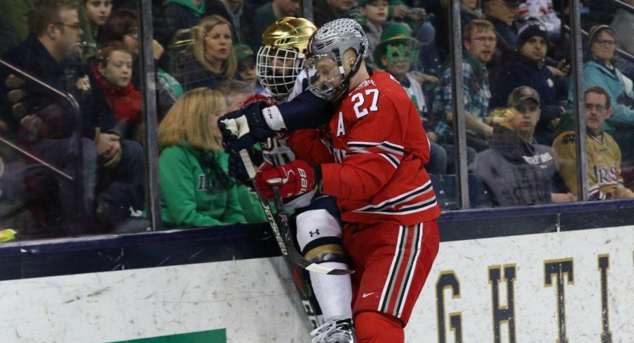 Buckeye forward Luke Stork plasters the glass with an Irish skater.