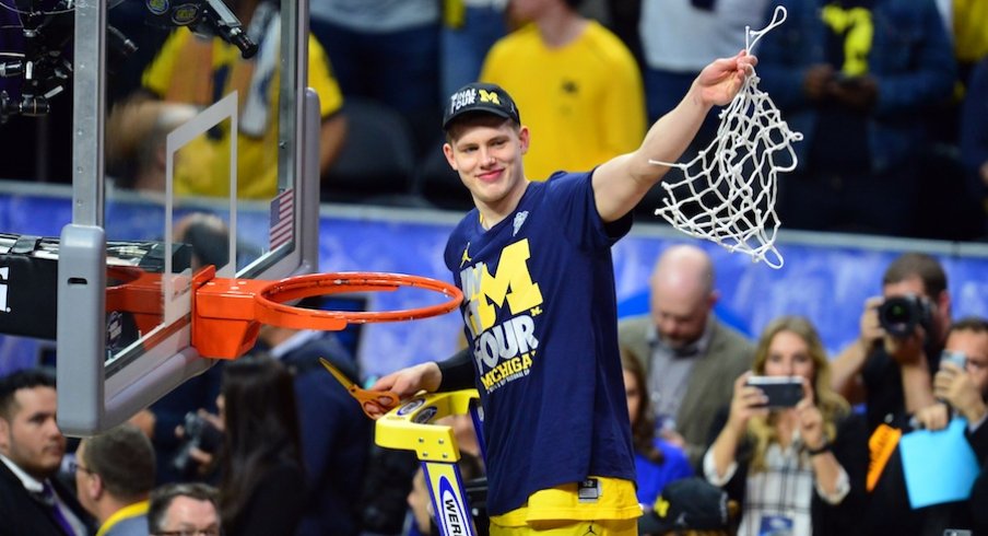 March 24, 2018; Los Angeles, CA, USA; Michigan Wolverines forward Moritz Wagner (13) cuts down the net following the 58-54 victory against the Florida State Seminoles in the championship game of the West regional of the 2018 NCAA Tournament at STAPLES Center.