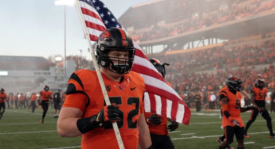 Oct 26, 2017; Corvallis, OR, USA; Oregon State Beavers offensive lineman Sumner Houston (52) carries the American Flag onto the field before the game against the Stanford Cardinal at Reser Stadium. Mandatory Credit: Scott Olmos-USA TODAY Sports