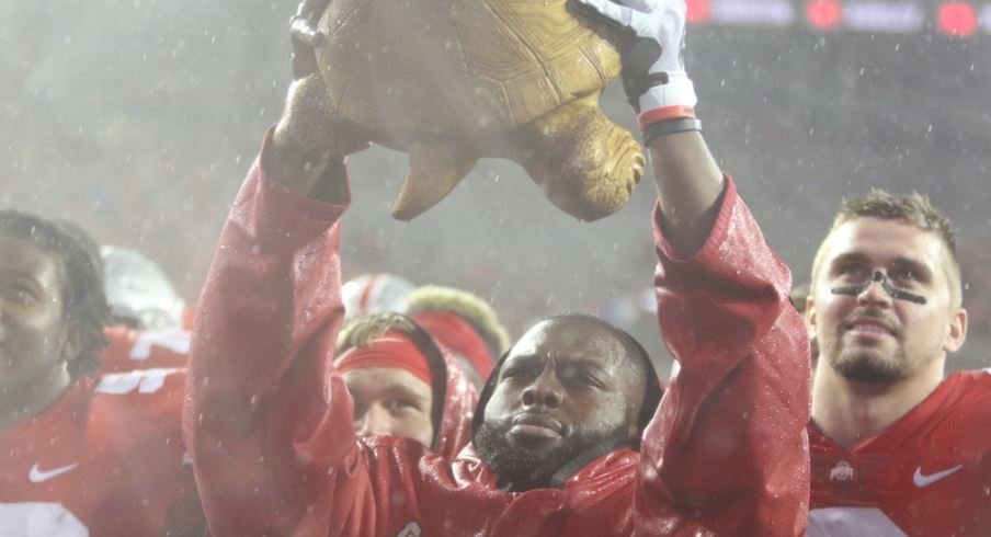 Former Ohio State quarterback J.T. Barrett holds aloft Illibuck