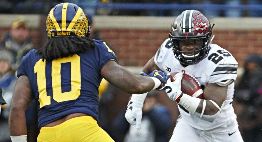 Nov 25, 2017; Ann Arbor, MI, USA; Ohio State Buckeyes running back Mike Weber (25) rushes at Michigan Wolverines linebacker Devin Bush (10) in the second half at Michigan Stadium. Mandatory Credit: Rick Osentoski-USA TODAY Sports