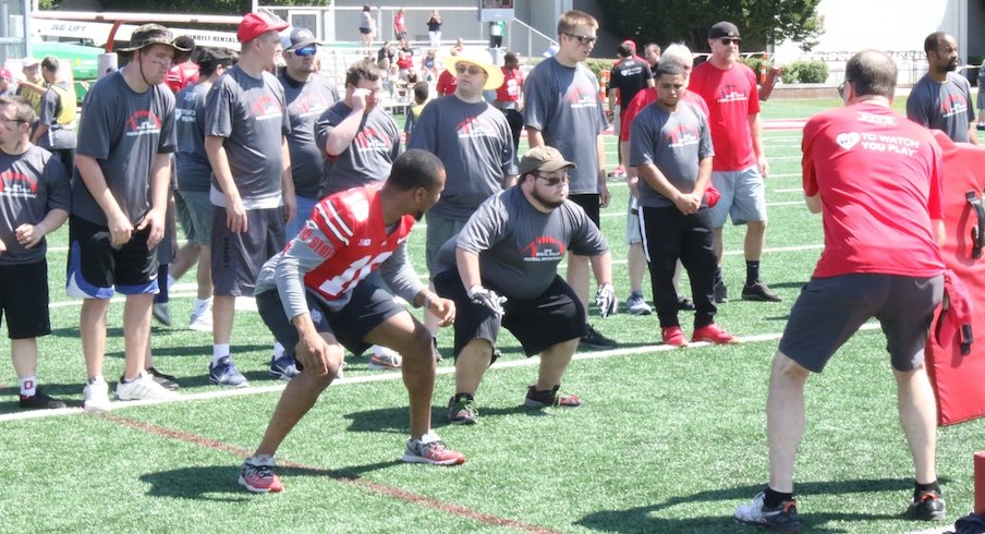 Keandre Jones coaches a participant at the Special Skills Football Invitational.