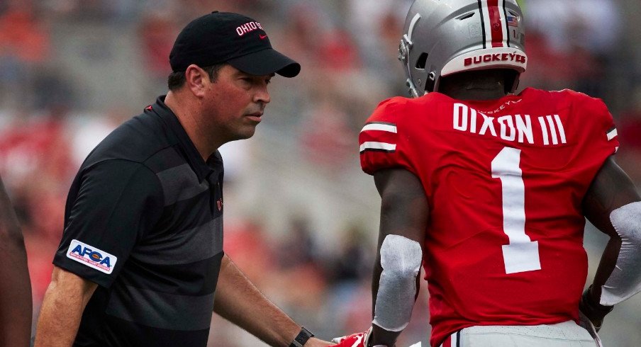 Ohio State acting head coach Ryan Day talks to Ohio State wide receiver Johnnie Dixon (1) during the second half against the Oregon State Beavers at Ohio Stadium.