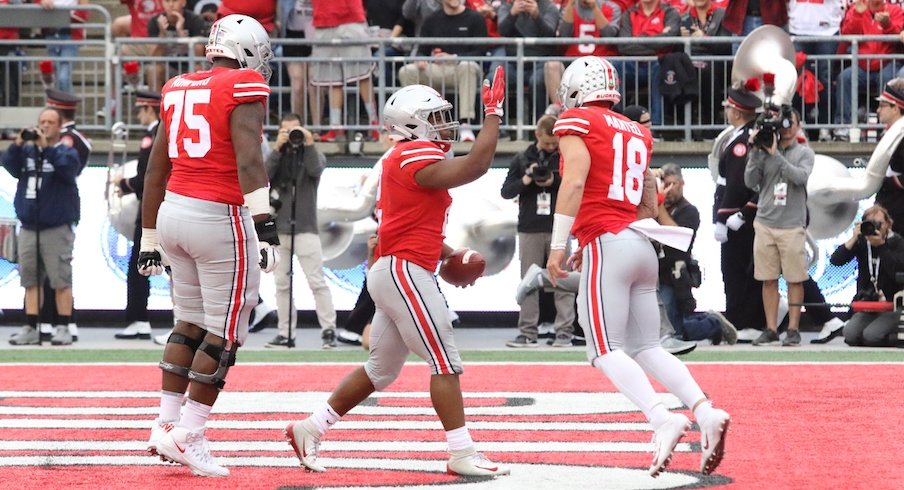 Thayer Munford, J.K. Dobbins and Tate Martell celebrate a Dobbins touchdown.