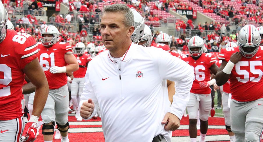 Urban Meyer runs out onto the field in his first game back from suspension.