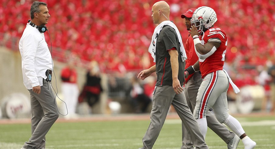 Mike Weber limps off the field after suffering an injury against Tulane on Saturday.