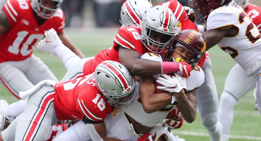 Oct 13, 2018; Columbus, OH, USA; Minnesota Golden Gophers wide receiver Demetrius Douglas (82) is tackled by Ohio State Buckeyes linebacker Dallas Gant (19) and linebacker Keandre Jones (16) during the second quarter at Ohio Stadium. Mandatory Credit: Joe Maiorana-USA TODAY Sports