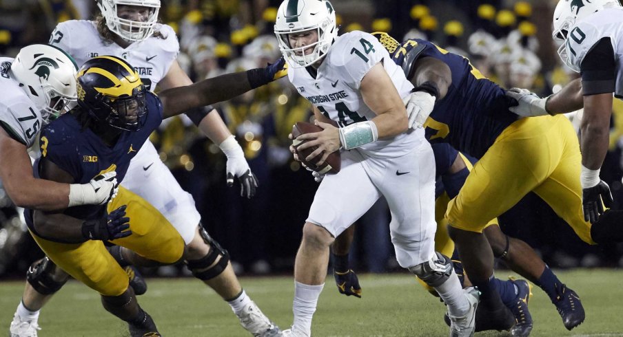 Brian Lewerke escapes the Michigan defensive line