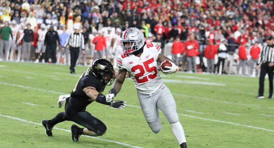 Mike Weber escapes an attempted tackle from Purdue's Thieneman