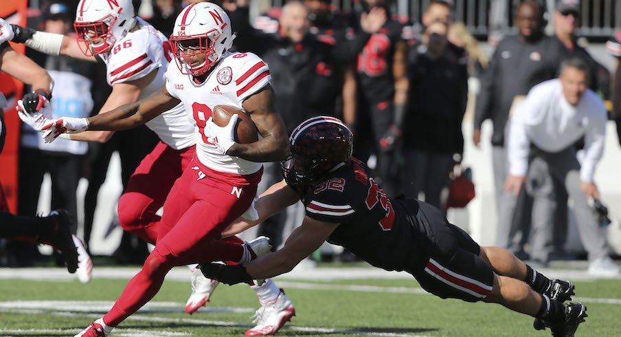 Tuf Borland makes a tackle as Stanley Morgan Jr. tries to get away from him in Saturday's game.