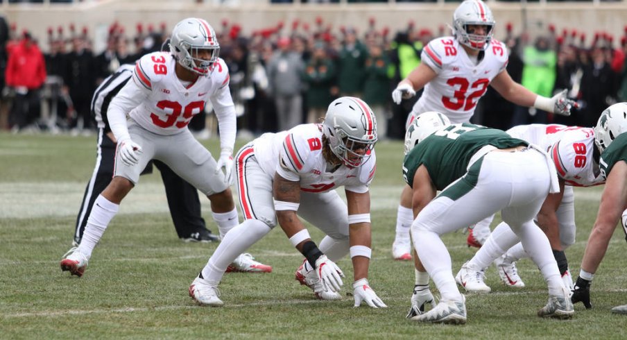 Chase Young, Malik Harrison, and Tuf Borland eye their prey. 