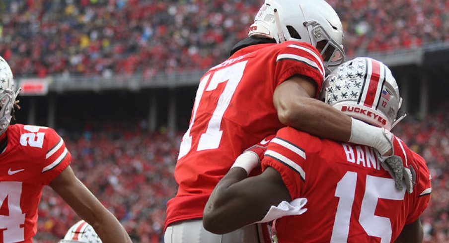 Chris Olave and Sevyn Banks celebrate teaming up for a blocked punt for a touchdown in the win over Michigan.