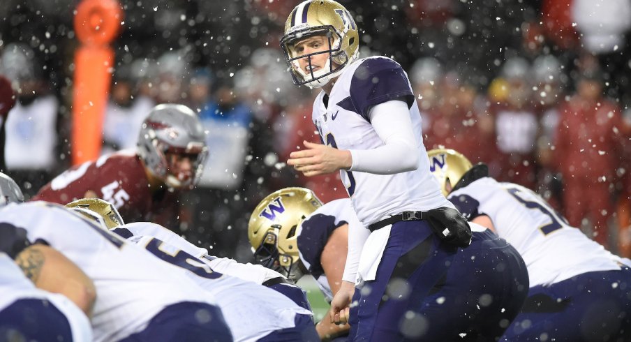 Jake Browning reads the defense before taking snap in the snow. 