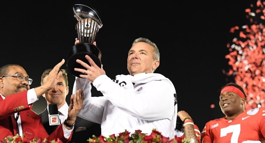 Urban Meyer hoists the Rose Bowl trophy after Ohio State defeated Washington in Pasadena.