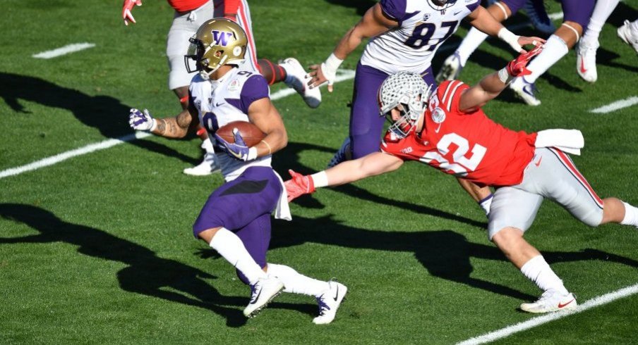 Myles Gaskin runs past Tuf Borland in the Rose Bowl. 