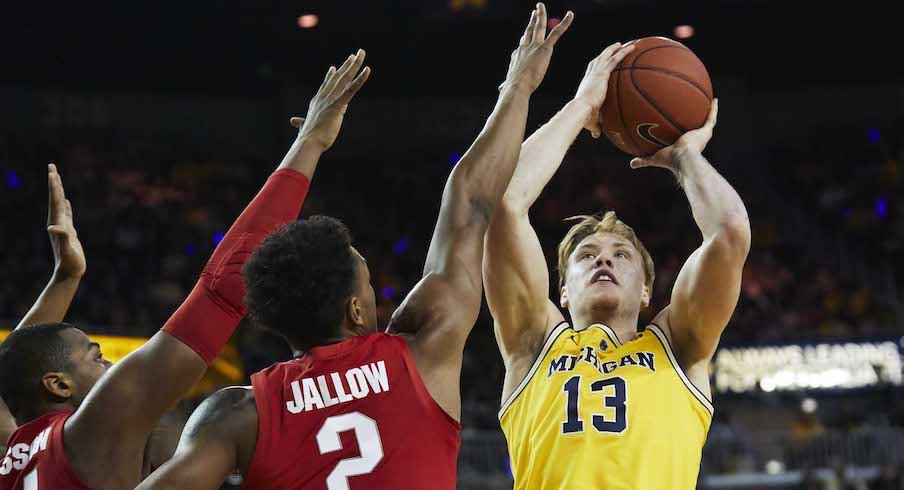 Ignas Brazdeikis shoots over Ohio State's Kaleb Wesson and Musa Jallow