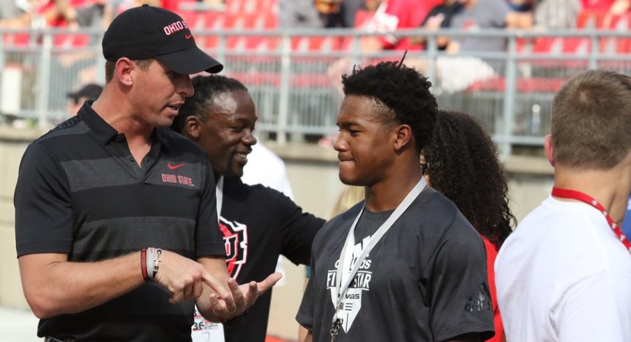 WR coach Brian Hartline talks to a recruit