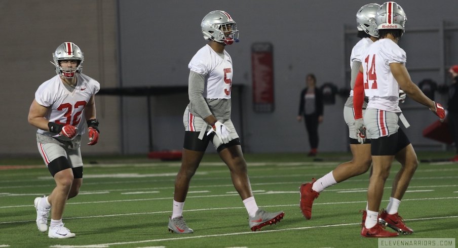 Ohio State defensive players, including Tuf Borland (32), Baron Browning (5) and Isaiah Pryor (14).