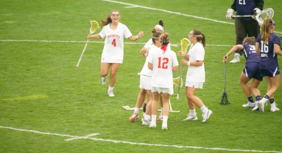 Women's lacrosse celebrates a goal against Northwestern