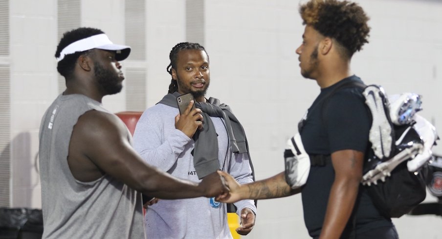 Brandon Collier (middle) and Tyrese Owusu-Bediako (right) meet Robert Landers at Thursday's Ohio State football camp.