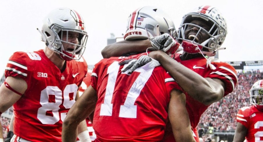 Nov 24, 2018; Columbus, OH, USA; Ohio State Buckeyes wide receiver Chris Olave (17) is congratulated by tight end Luke Farrell (89) and wide receiver Binjimen Victor (9) after scoring a touchdown against the Michigan Wolverines at Ohio Stadium. Mandatory Credit: Greg Bartram-USA TODAY Sports