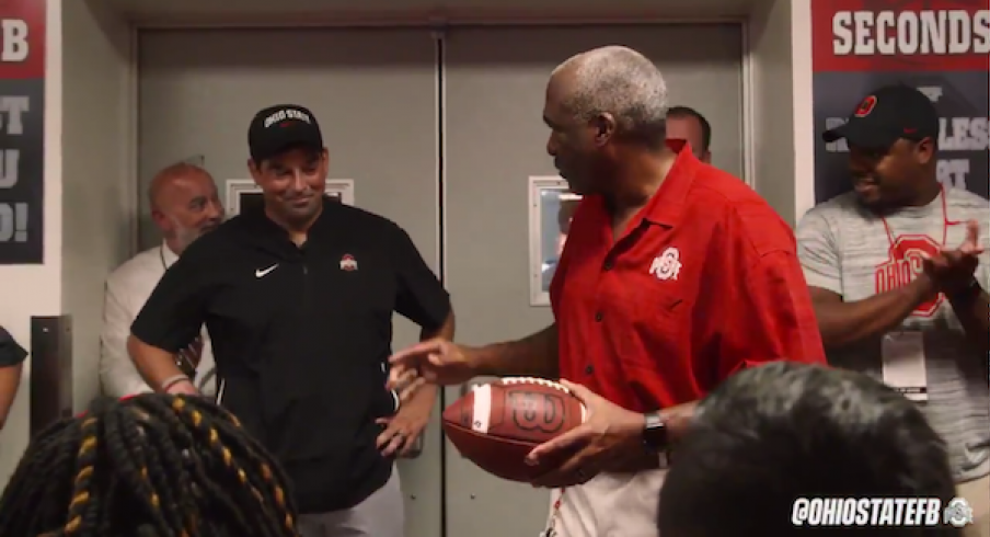 Gene Smith gives Ryan Day the game ball.