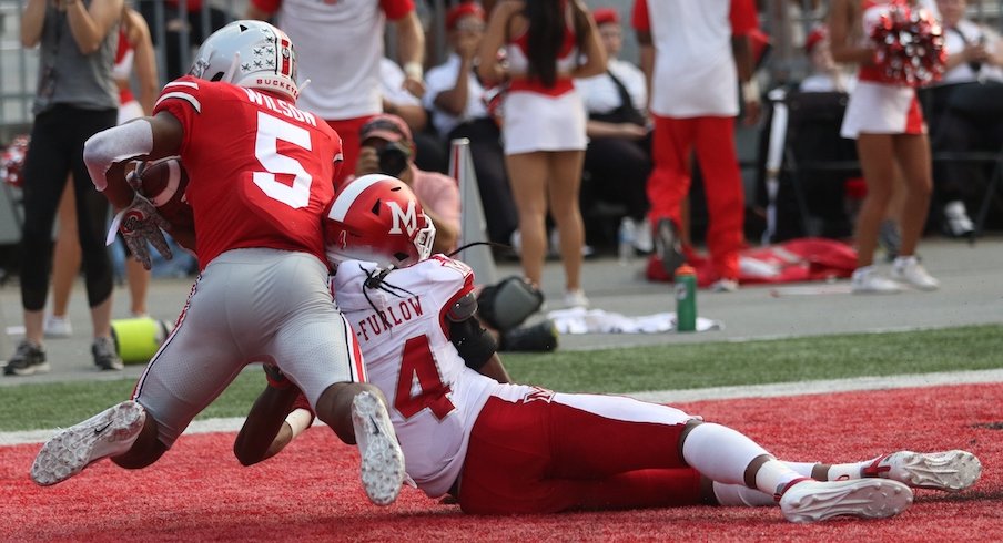 Garrett Wilson catches a touchdown pass against Miami.